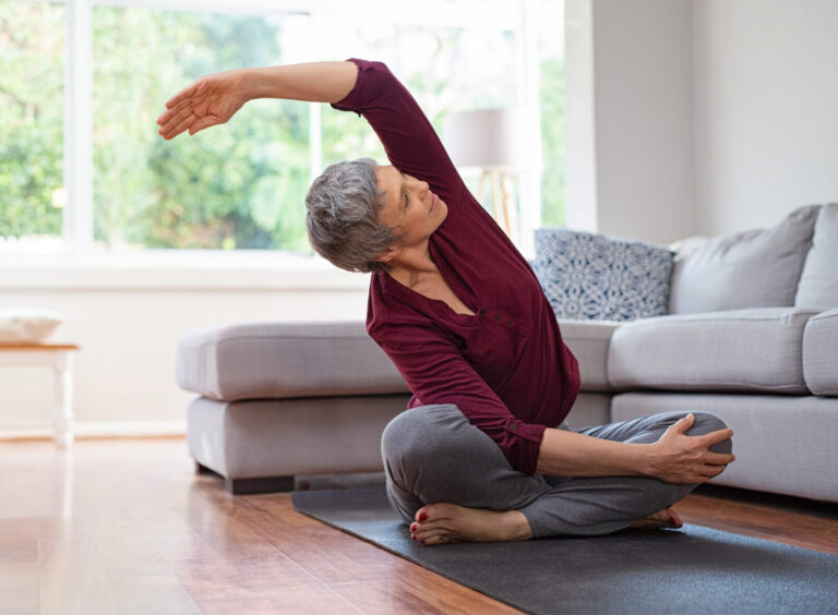 Image of an active mature woman doing yoga stretching